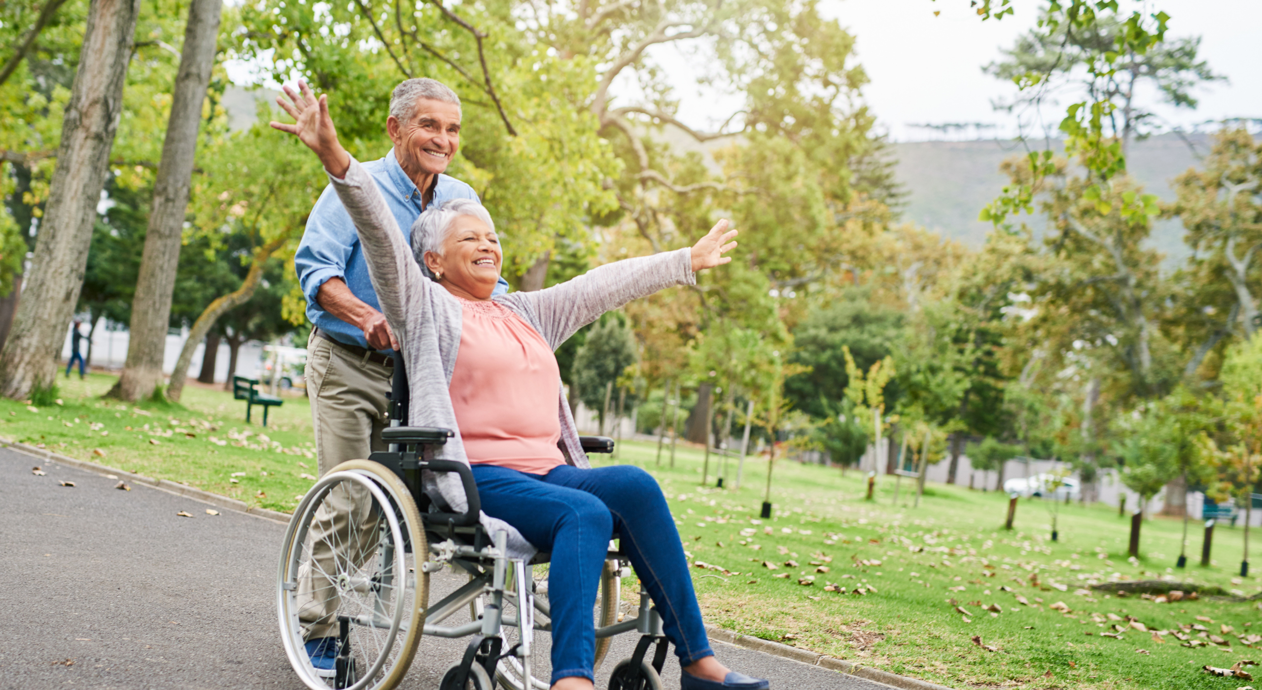 Elderly couple enjoying a park stroll.